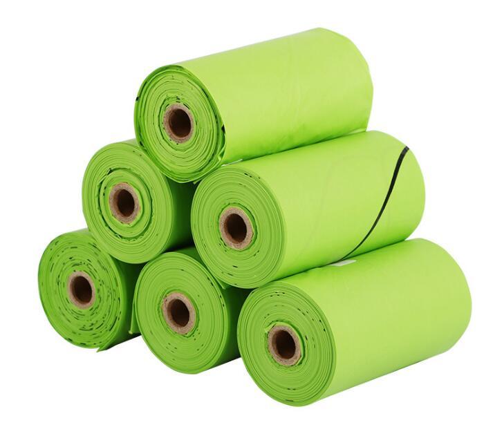 Six rolls of Yellow Lavender Dog Waste Bags - Compostable, 120 count-Plant Based are stacked in a pyramid shape against a white background.
