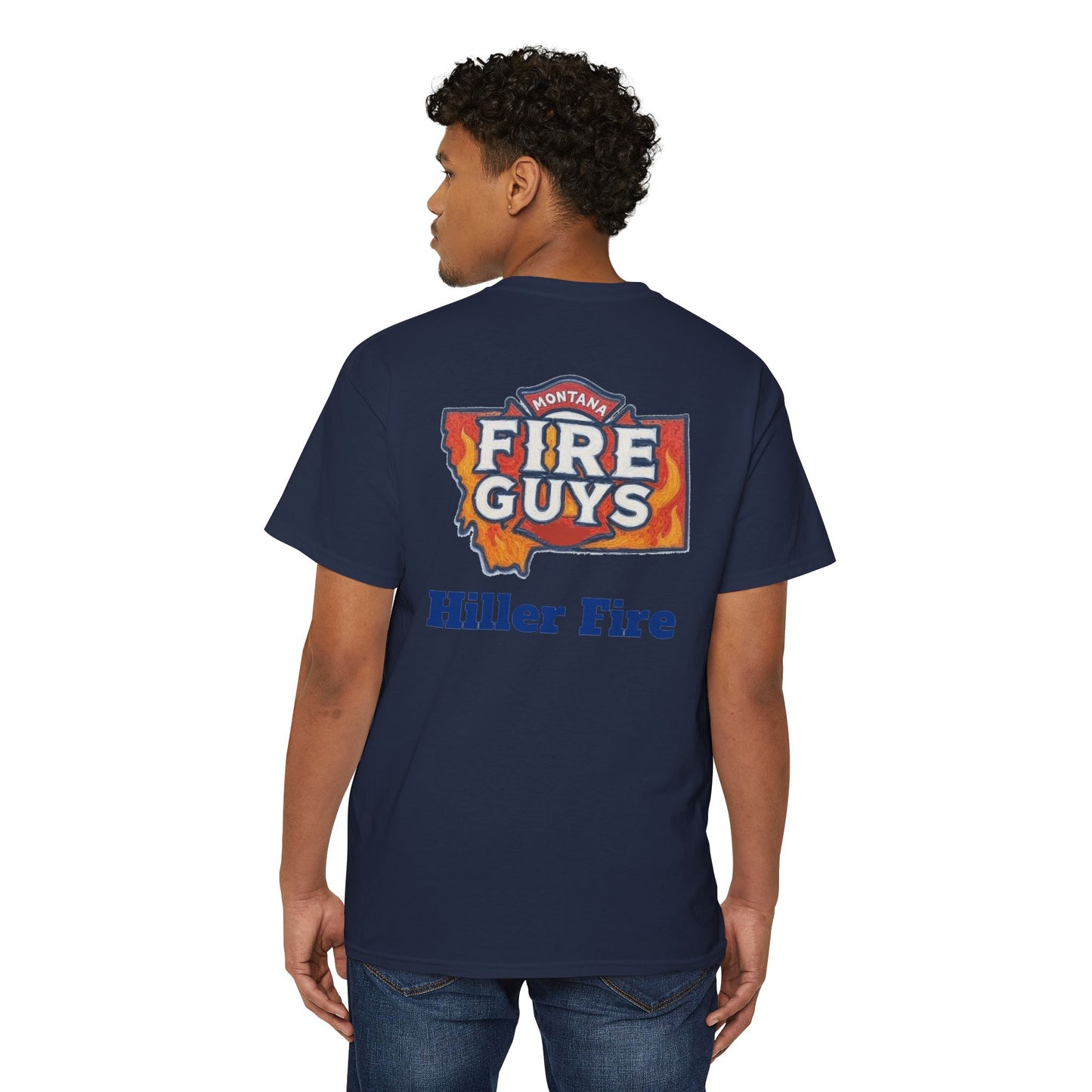 A man confidently stands wearing a navy Unisex Heavy Cotton Pocket Tee by Printify. With the "Hiller Fire Guys" graphic and "Hiller Fire" text on the back, this T-shirt is a comfortable and stylish staple for firefighters and outdoor enthusiasts. He glances over his shoulder with poise.