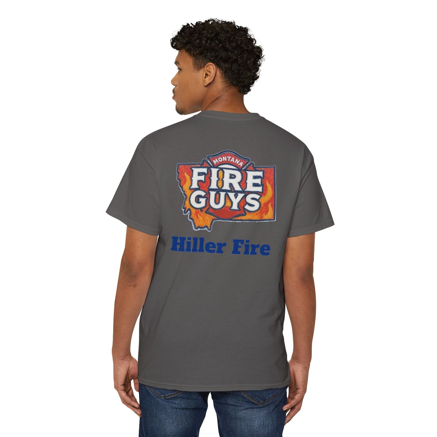Someone with curly hair is set for casual outings wearing a dark gray Printify Unisex Heavy Cotton Pocket Tee featuring the "Hiller Fire Guys" design. Paired with jeans, it's an ideal choice for outdoor activities.