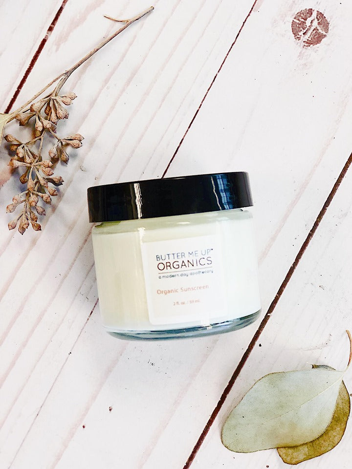 A jar of Natural Organic Sunscreen with eucalyptus leaves and SPF 45 Sunscreen from White Smokey.