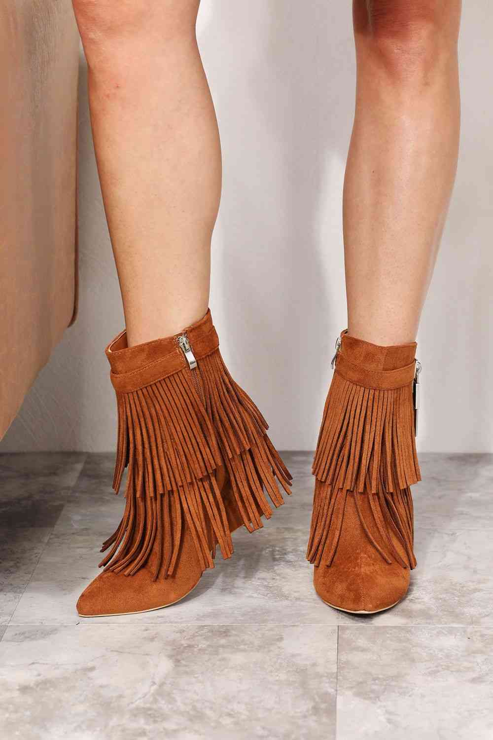 Legend Women's Tassel Wedge Heel Ankle Booties by Trendsi featuring an open shank design. Made with vegan suede for a stylish and cruelty-free look.