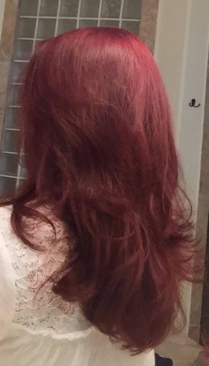 Back view of a woman with vibrant red hair washed with White Thalassa Organic Caffeine Hair Growth Shampoo.