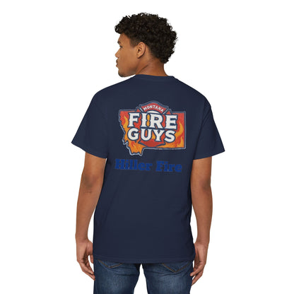 A man confidently stands wearing a navy Unisex Heavy Cotton Pocket Tee by Printify. With the "Hiller Fire Guys" graphic and "Hiller Fire" text on the back, this T-shirt is a comfortable and stylish staple for firefighters and outdoor enthusiasts. He glances over his shoulder with poise.