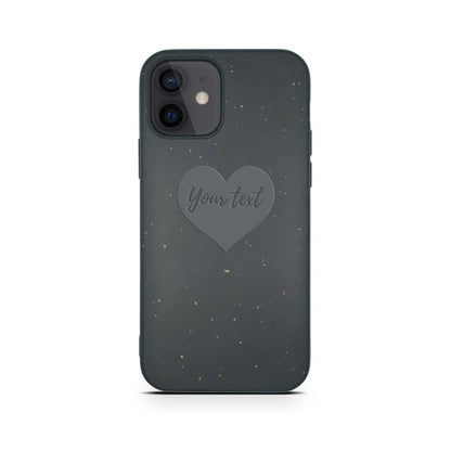 A smartphone with an eco-friendly Tan Lily Biodegradable Personalized iPhone Case in black featuring a customizable heart-shaped text area on the back.
