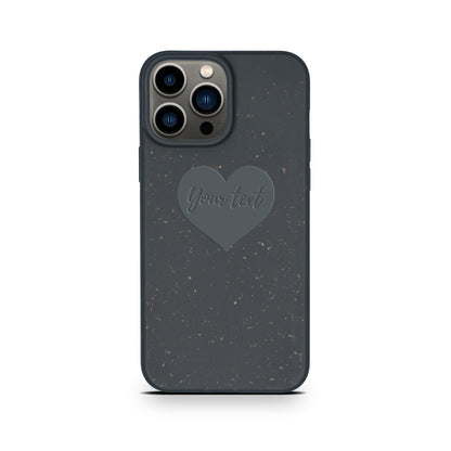 A Tan Lily smartphone with a Biodegradable Personalized Iphone Case in black featuring a heart-shaped design and the text "your text" on the back.