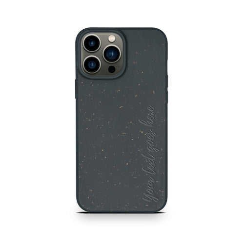 A black speckled eco-friendly Tan Lily biodegradable personalized iPhone case on an iPhone with a triple camera setup, featuring the cursive text "Never Settle" on the back.