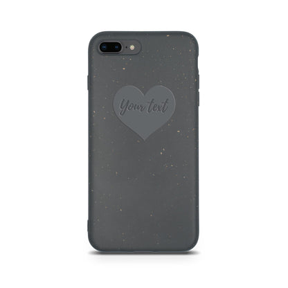 An eco-friendly Tan Lily Biodegradable Personalized iPhone Case - Black with a heart-shaped cutout containing the text "Your text".