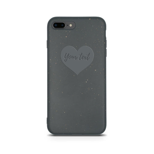 An eco-friendly dark grey smartphone case with a speckled design, featuring a heart-shaped outline and the phrase "Your text" in the center. Biodegradable Personalized Iphone Case - Black by Tan Lily.