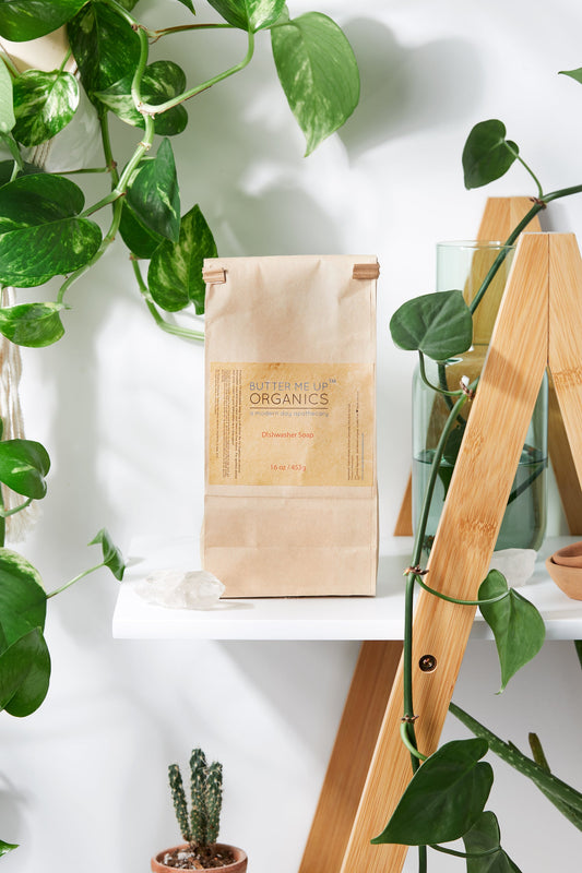 A bag of White Smokey organic coffee sitting on a shelf next to a plant.