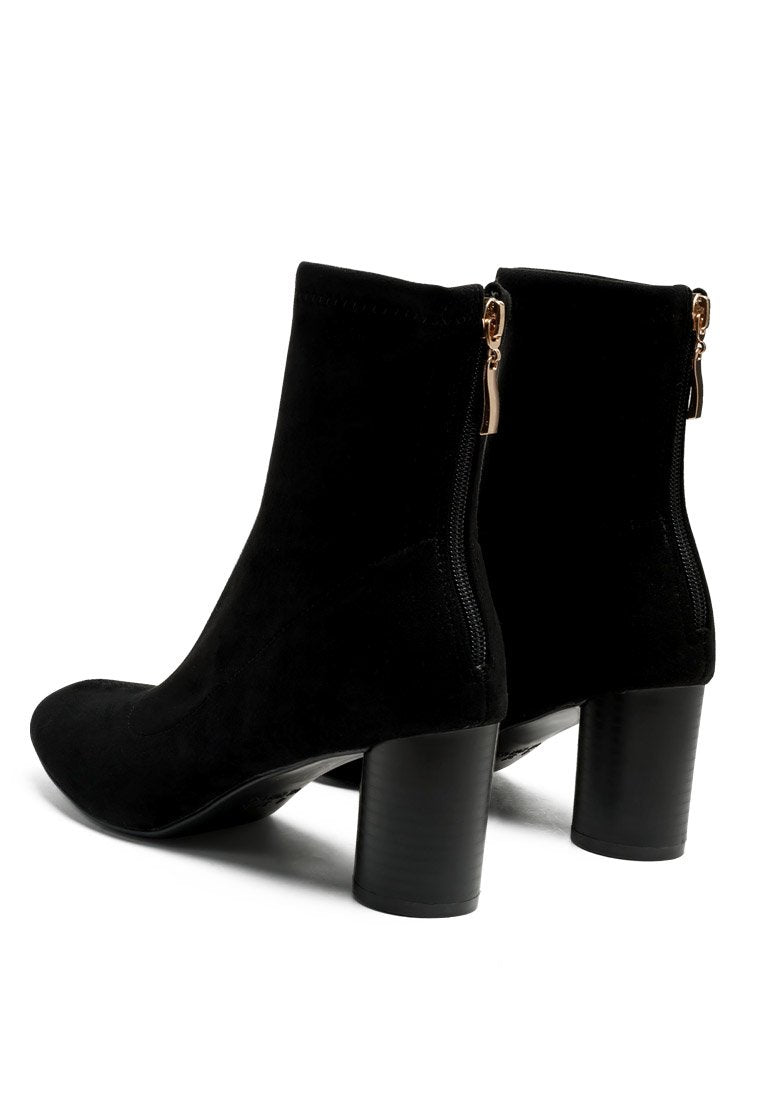 A pair of black Vegan Micro Suede ankle boots by Ruby Smudge with high block heels and side zippers.