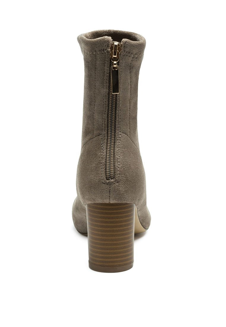 Rear view of a Ruby Smudge Vegan Micro Suede Ankle Boot with a stacked heel and a zipper closure.