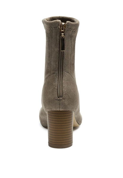Rear view of a Ruby Smudge Vegan Micro Suede Ankle Boot with a stacked heel and a zipper closure.