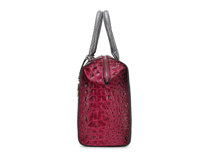 A Pink Orpheus Ember Faux Crocodile-Embossed Vegan Leather Women’s Satchel bag with an adjustable strap on a white background.
