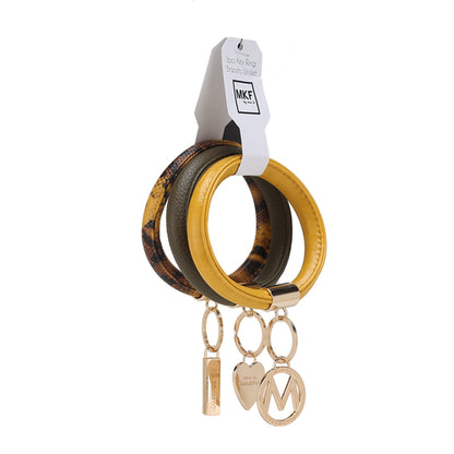 A set of Jasmine Vegan Leather Women Bangle Wristlet Keychain set with charm pendants and a tag indicating the brand Pink Orpheus, crafted from vegan leather materials.