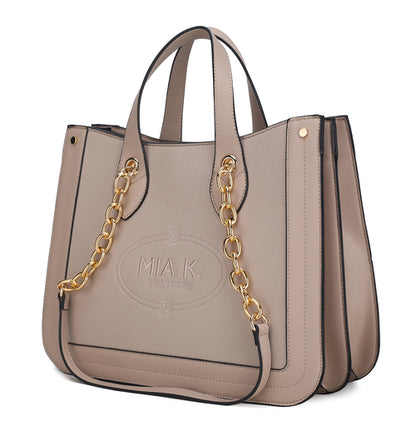 A Stella Vegan Leather Women Tote Bag by Pink Orpheus, with gold chain handles, perfect for carrying daily essentials.