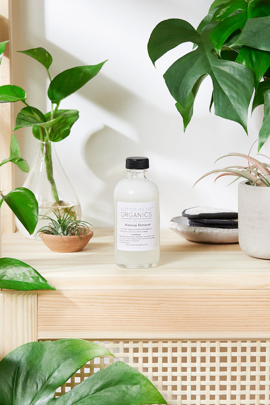 An efficient White Smokey Organic Makeup Remover, toxin-free, gentle for sensitive skin, sits on a shelf next to a potted plant.
