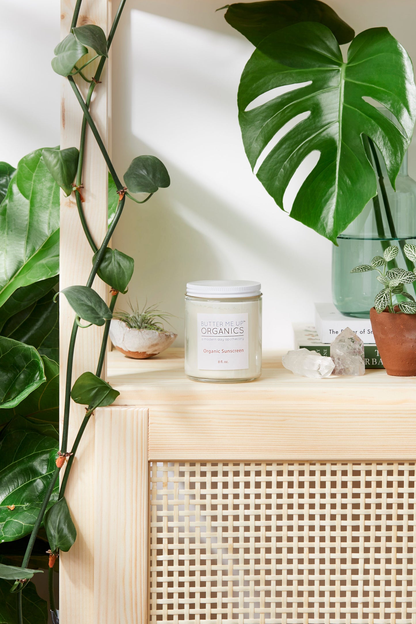 A wooden shelf with White Smokey Natural Organic Sunscreen, Safe Sunscreen, and Non-Nano Zinc Oxide on it.