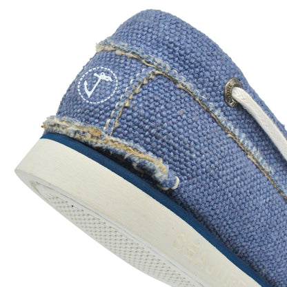 Close-up of a blue textured Amethyst Hestia Men Hemp & Vegan Boat Shoe Fidden with white laces, featuring a small logo on the side and a white sole.