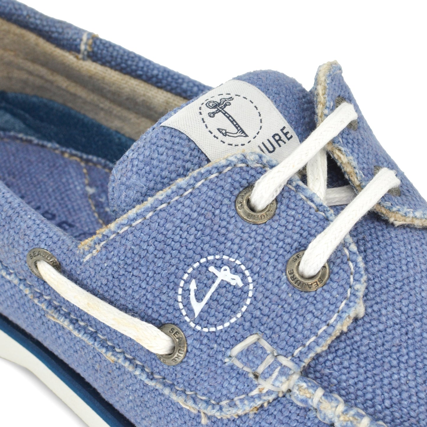 Close-up of a pair of worn Men Hemp & Vegan Boat Shoe Fidden sneakers by Amethyst Hestia with white laces and natural rubber eyelets, displaying visible signs of wear and fading.
