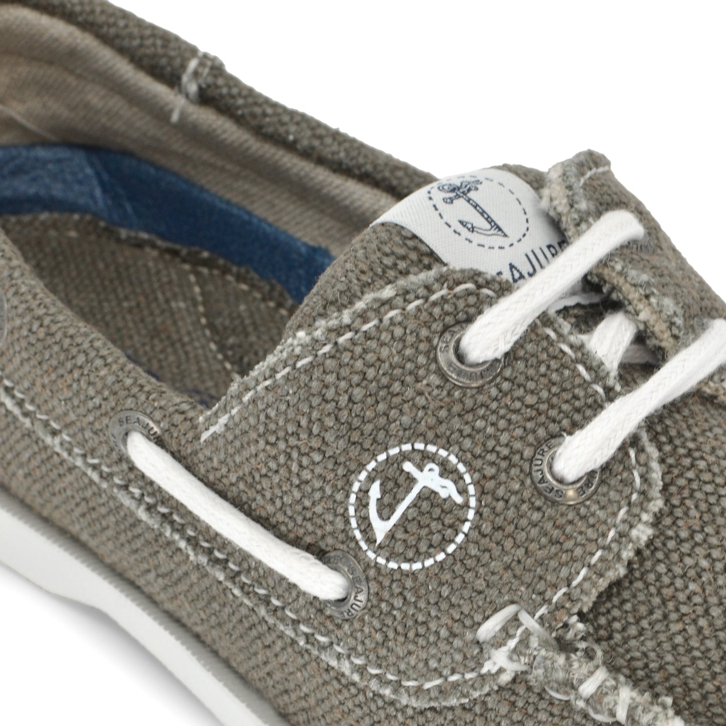 Close-up of a grey Amethyst Hestia Men Hemp & Vegan Boat Shoe Scopello with white laces and an anchor logo on the side. The shoe, made from premium hemp, displays visible stitching and a small tag near the laces.