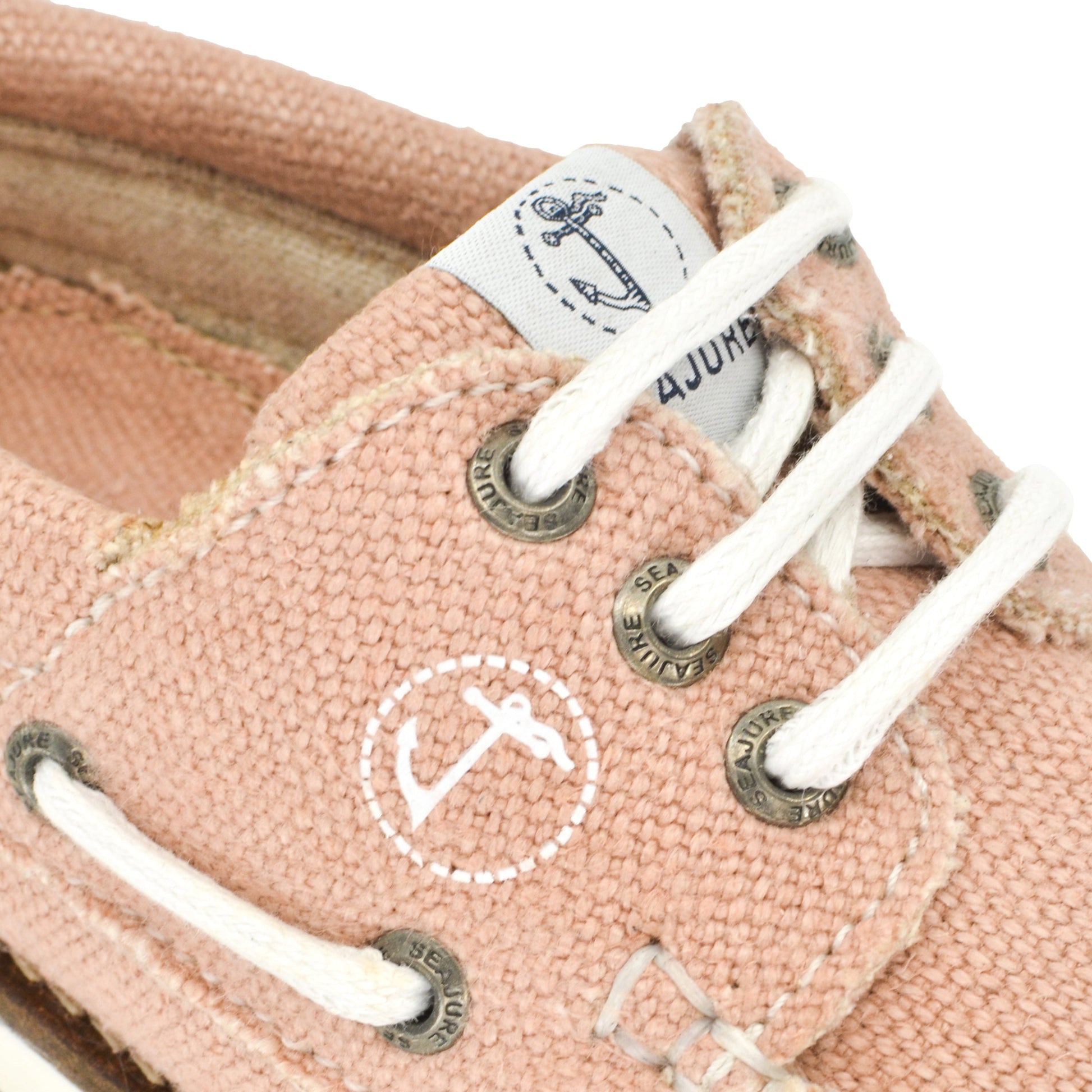 Close-up of a pink canvas sneaker made from premium hemp, with white laces and metal eyelets, showing a worn texture and a logo on the tongue. Women Hemp & Vegan Boat Shoe Pasjaca by Amethyst Hestia.
