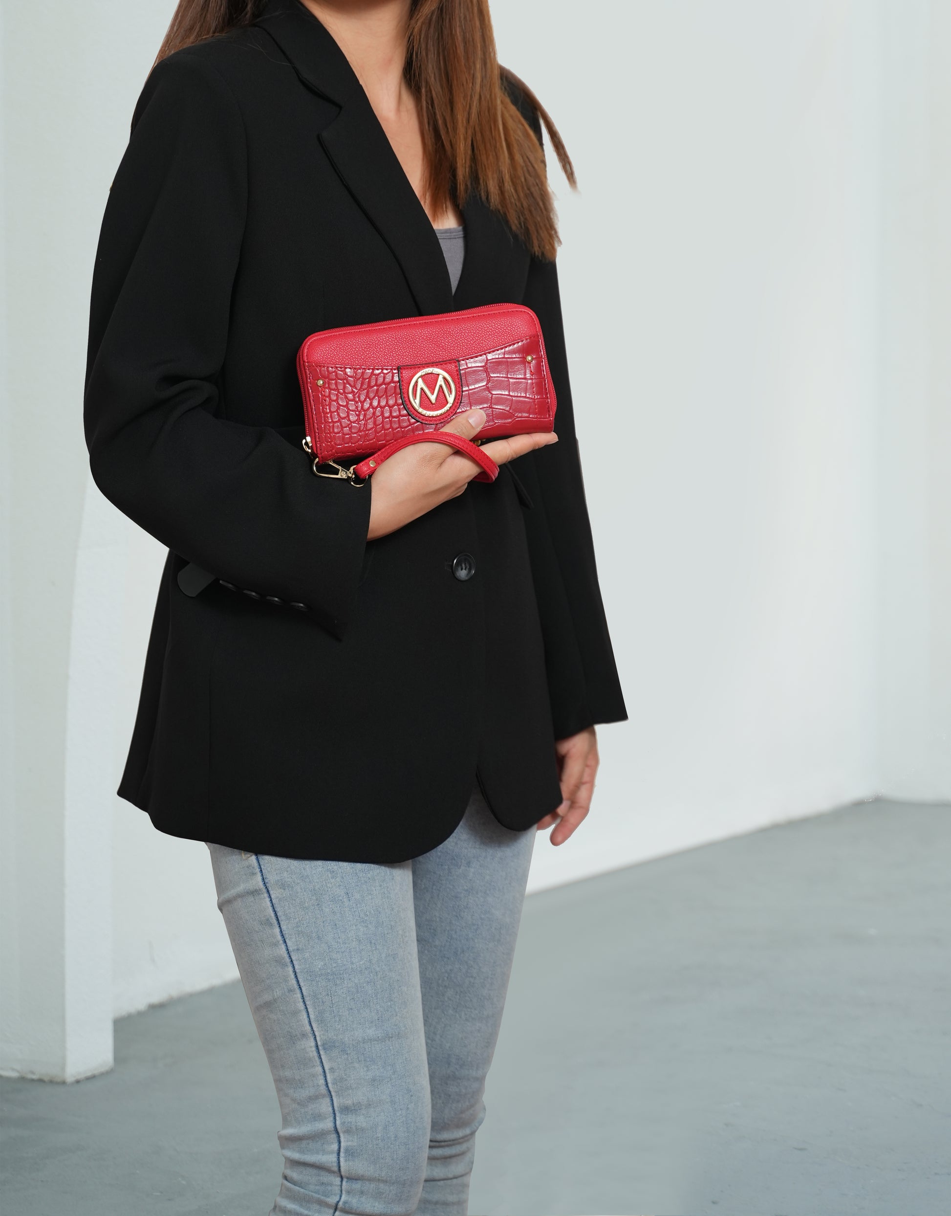 A woman in a blazer and jeans holding a Pink Orpheus Virginia Vegan Leather Women Tote Bag with Wallet.