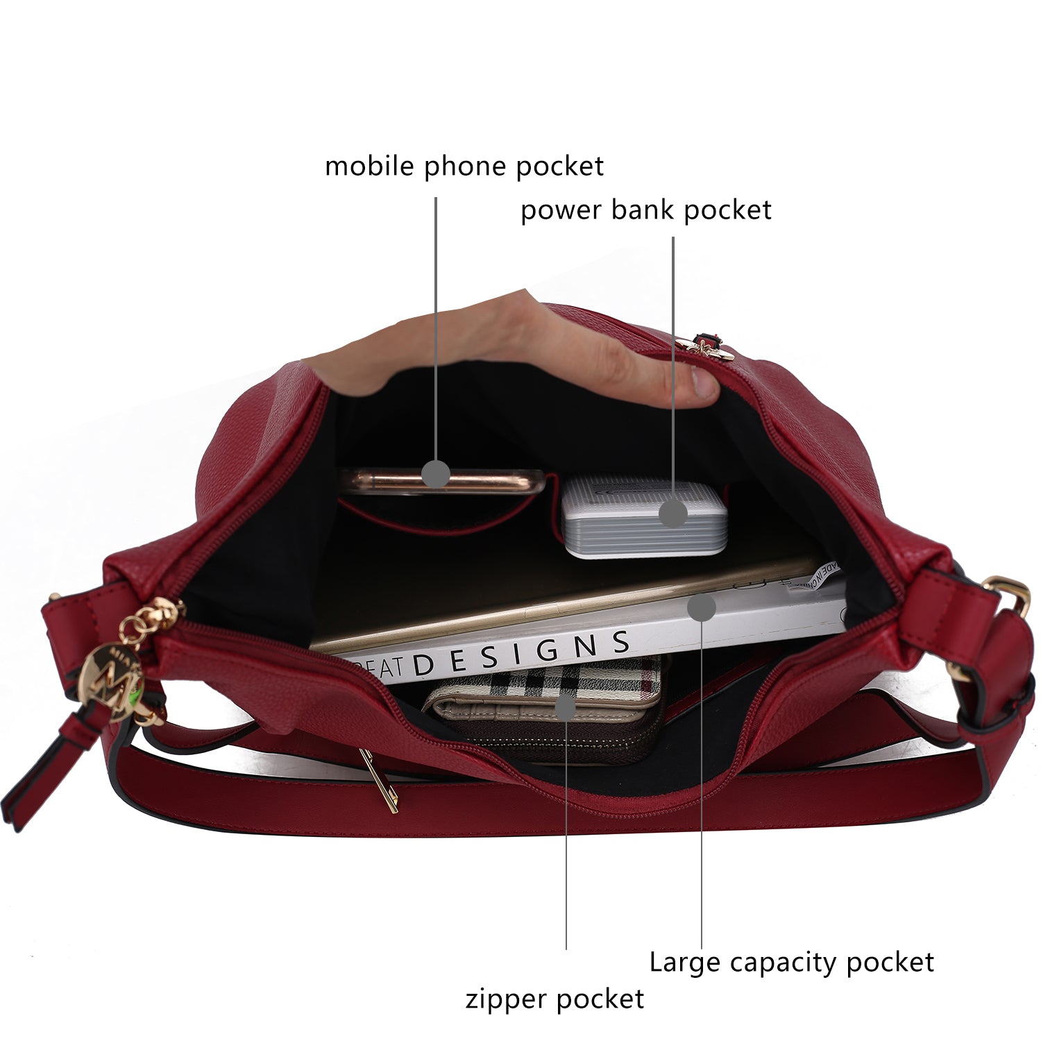 A Lavinia Vegan Leather Women’s Shoulder Bag by Pink Orpheus with gold-tone embellishments and a cell phone inside.