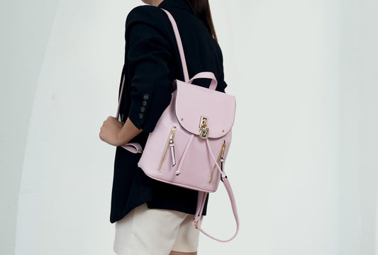 A woman wearing the Pink Orpheus Xandria Vegan Leather Women Backpack.