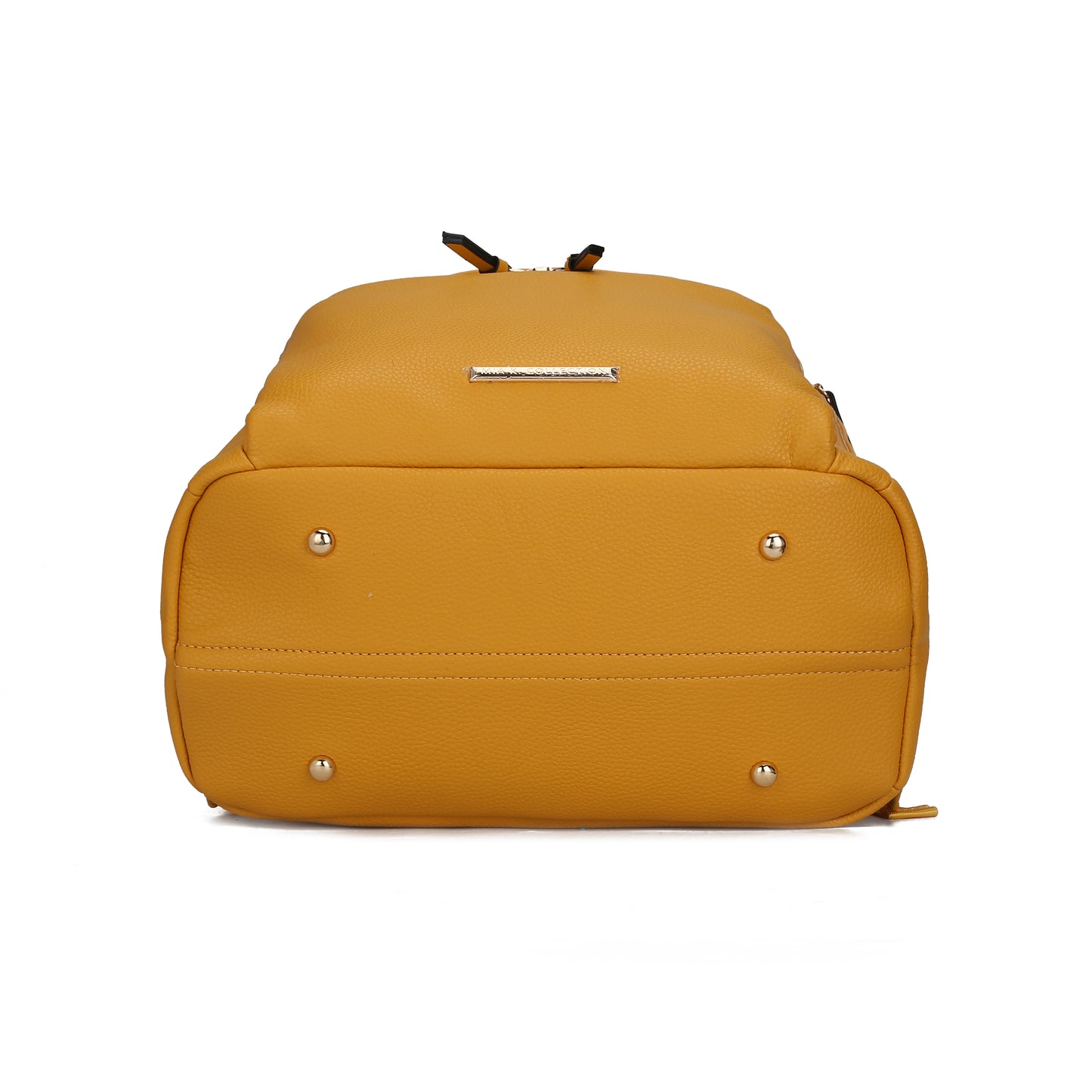 The mustard yellow Angela Large Backpack Vegan Leather by Pink Orpheus, displayed bottom side up, features metal feet for stability along with a small metallic label at the top—perfect for stylish travel.