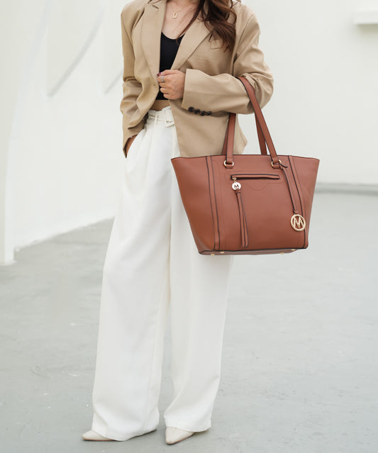 A woman wearing a tan blazer and white wide leg pants carrying a Pink Orpheus Alexandra Vegan Leather Women Tote Handbag with Wallet.