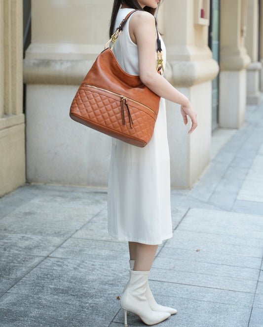 A sustainably stylish woman in a white dress holding a Dalila Vegan Leather Women Shoulder Handbag made by Pink Orpheus.