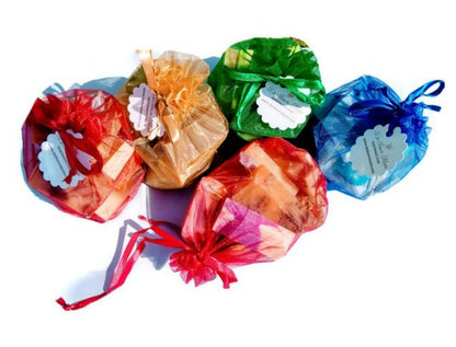 Five vibrant drawstring bags, each tagged with white labels and containing an assortment of handmade soaps, are arranged in a semi-circle, creating the perfect Yellow Shadow Assorted Vegan Soap Sampler - 1lb for an enhanced bath experience.