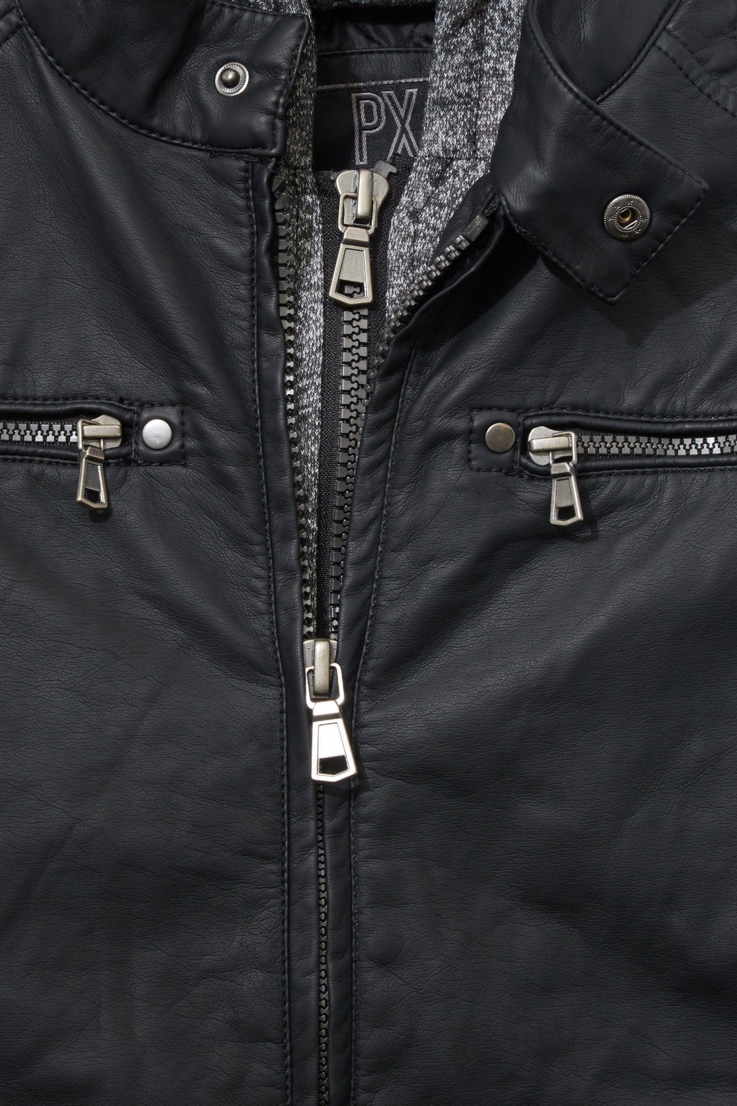 Close-up of a black Cyan Lily vegan leather moto jacket with zippers and a gray knit hoodie collar.