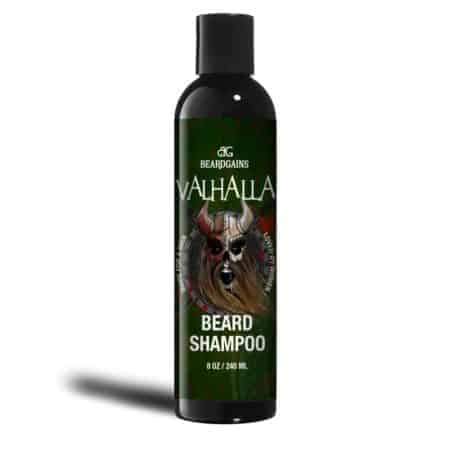 A black bottle labeled "Valhalla Organic Beard Shampoo" by Puce Oliver, featuring a Viking helmet and beard graphic on the front. This sulfate-free and paraben-free formula ensures your beard remains healthy and strong.