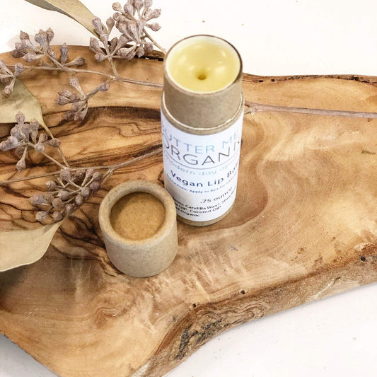 White Smokey's Natural VEGAN Lip Balm on a wooden surface with decorative elements.