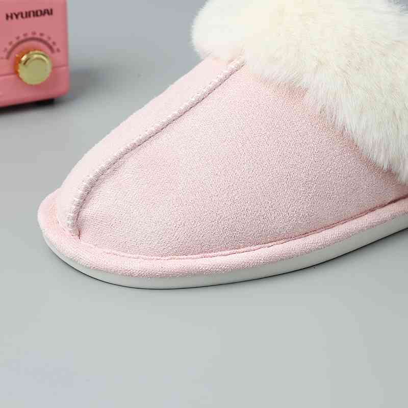 A pair of comfortable Trendsi Vegan Suede Center Seam Slippers next to a pink radio.
