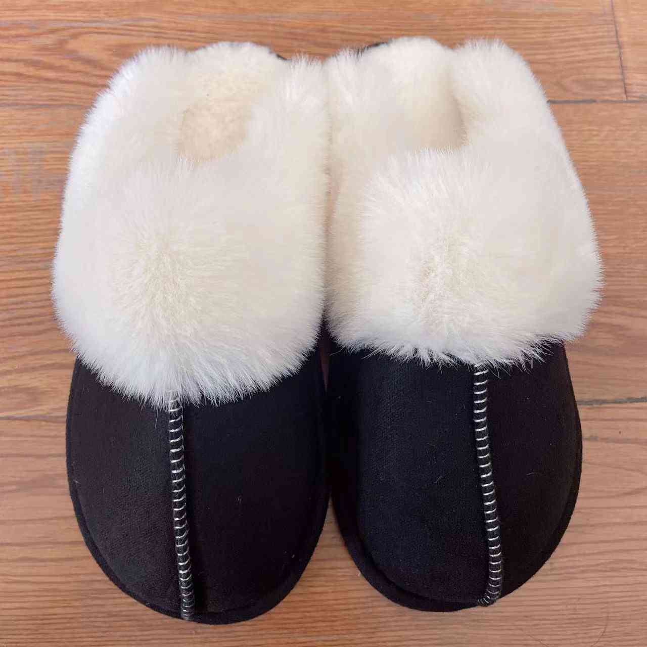 A pair of comfortable Trendsi vegan suede center seam slippers on a wooden floor.