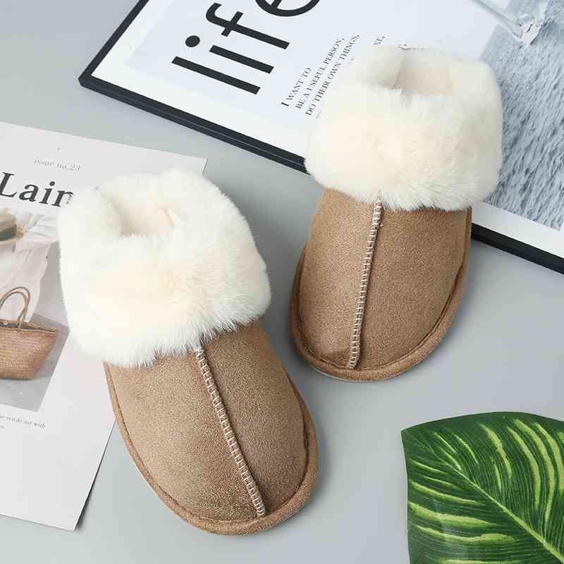 A pair of Trendsi women's vegan suede center seam slippers with fur on top, offering ultimate comfort for your feet.